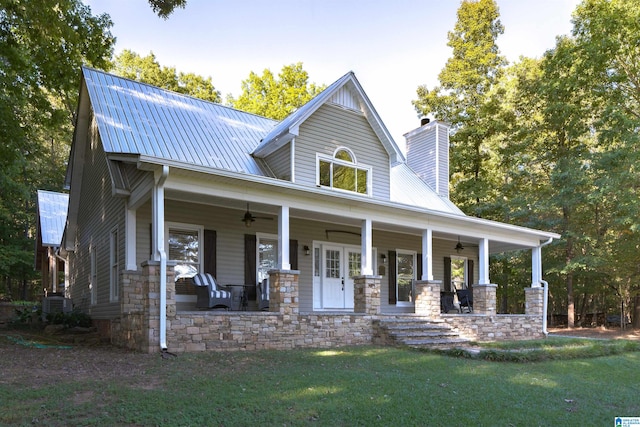 view of front of house featuring central air condition unit, a porch, a front yard, and ceiling fan