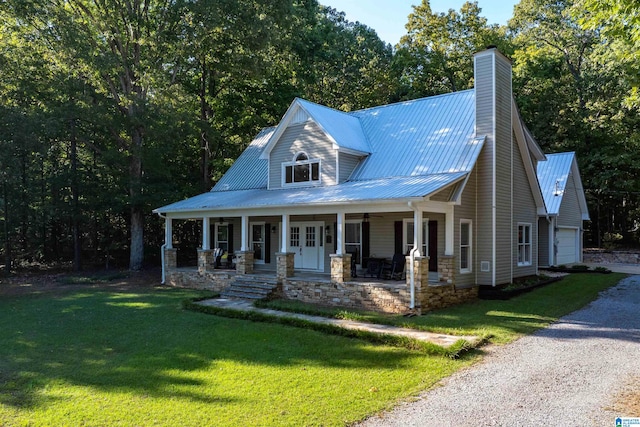 view of front facade featuring a garage, a porch, and a front lawn