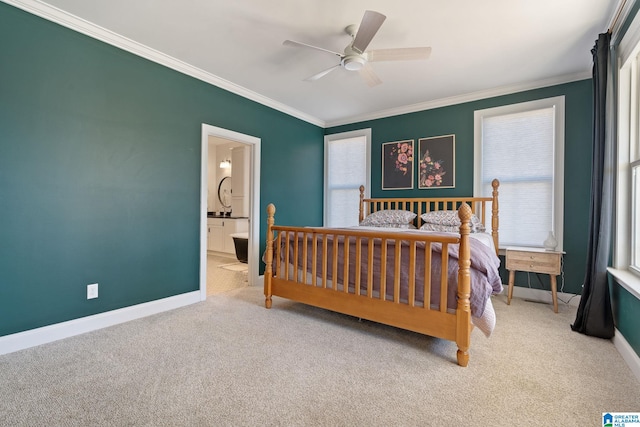 bedroom with ceiling fan, carpet floors, crown molding, and ensuite bathroom