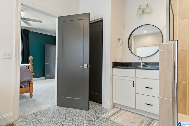 bathroom featuring ceiling fan and vanity