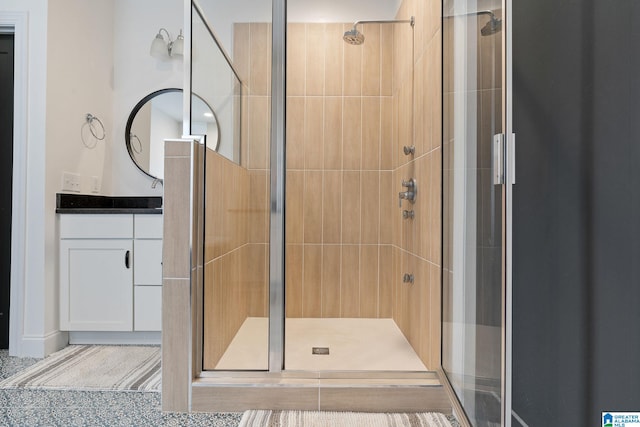 bathroom with vanity and a shower with door