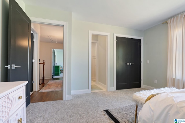 carpeted bedroom with a closet and ensuite bathroom