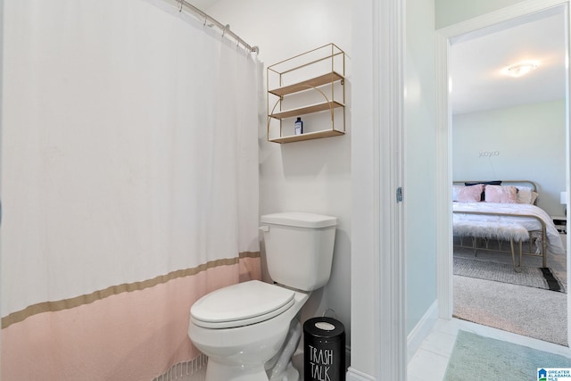 bathroom with walk in shower, tile patterned floors, and toilet