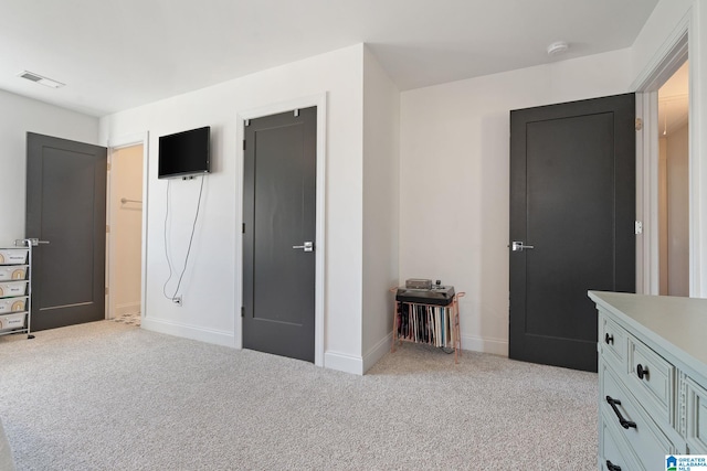 unfurnished bedroom featuring light colored carpet