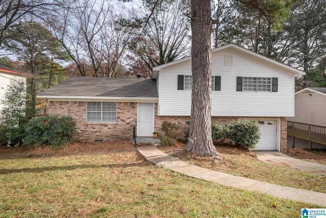 split level home featuring a front yard and a garage