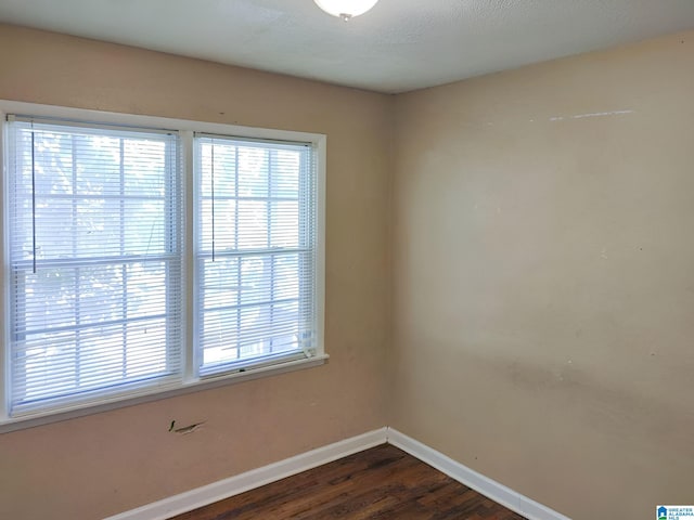 unfurnished room with dark hardwood / wood-style floors