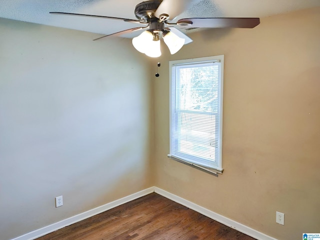 spare room with ceiling fan and dark wood-type flooring