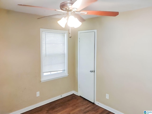 unfurnished room featuring dark hardwood / wood-style flooring and ceiling fan