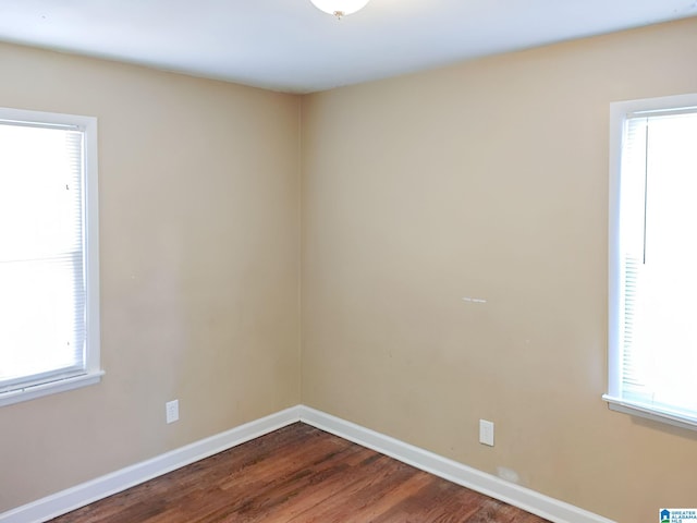 unfurnished room featuring hardwood / wood-style floors and a wealth of natural light