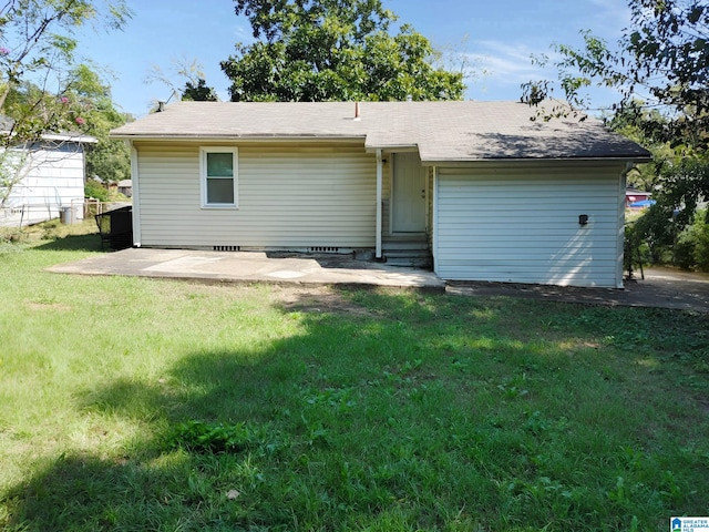 back of property with a patio and a yard