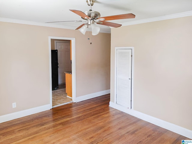 spare room with crown molding, hardwood / wood-style floors, and ceiling fan