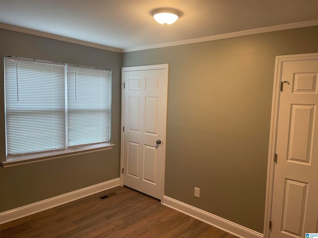 unfurnished room with dark hardwood / wood-style floors and crown molding