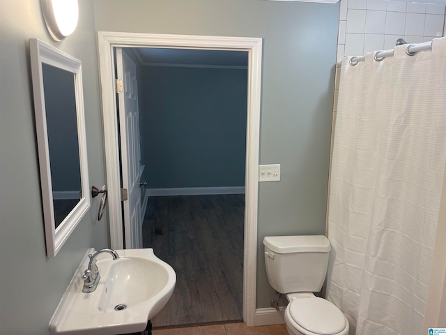 bathroom featuring hardwood / wood-style floors, sink, a shower with shower curtain, ornamental molding, and toilet