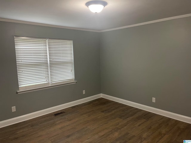 unfurnished room featuring dark wood-type flooring and crown molding