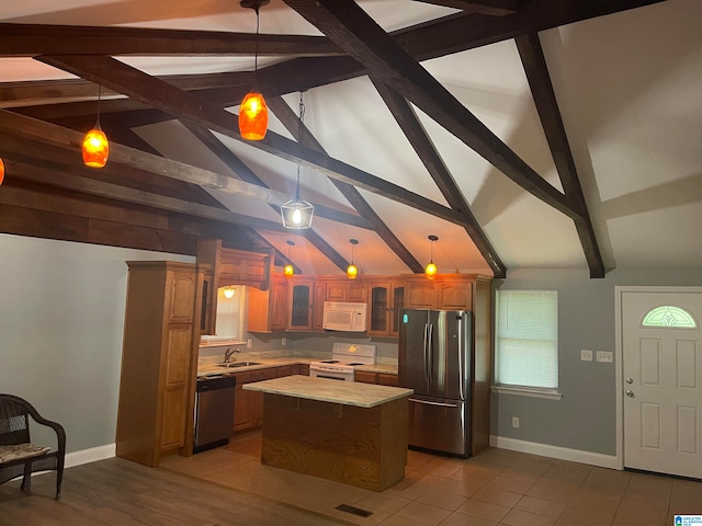 kitchen with a kitchen island, vaulted ceiling with beams, hanging light fixtures, and stainless steel appliances