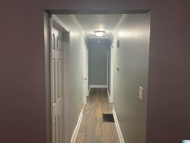 hall featuring ornamental molding and hardwood / wood-style flooring