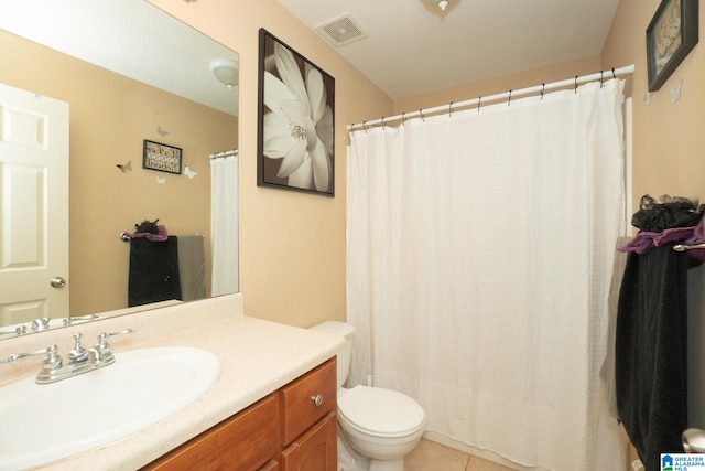 bathroom featuring tile patterned flooring, vanity, and toilet