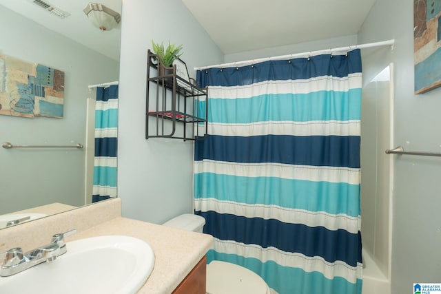 bathroom with a shower with shower curtain, vanity, and toilet