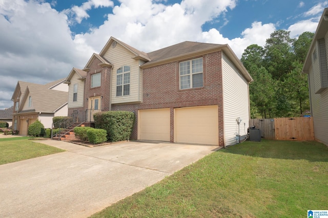 view of front of home with a front lawn, central air condition unit, and a garage