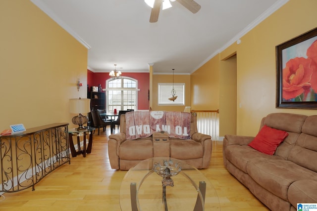 living room featuring ceiling fan with notable chandelier, crown molding, and light hardwood / wood-style flooring