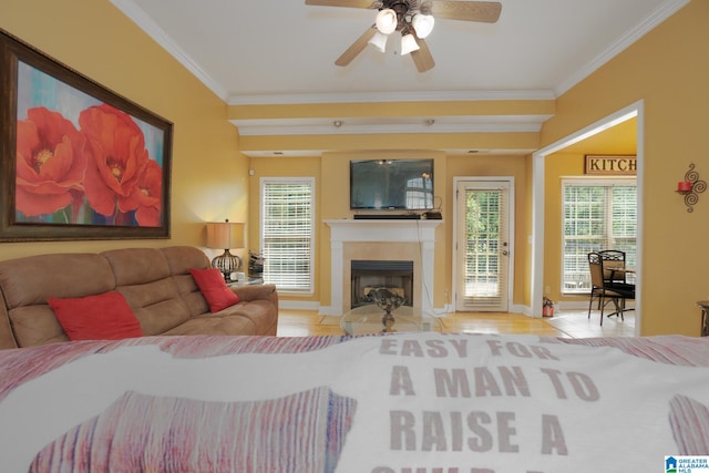 tiled living room with crown molding, a wealth of natural light, and ceiling fan