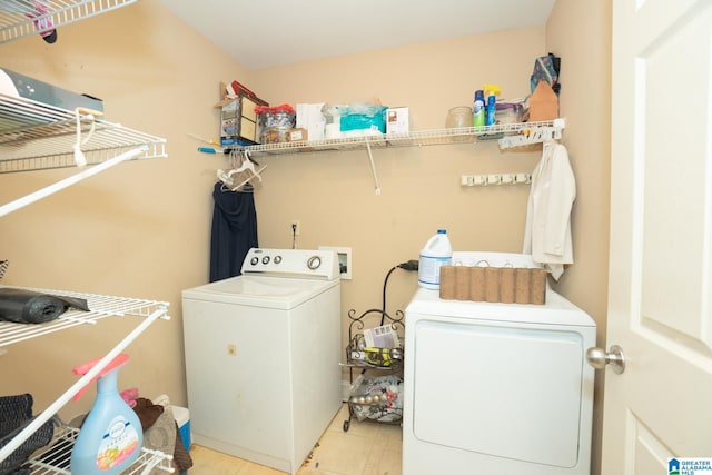 laundry area with light tile patterned floors and washing machine and dryer