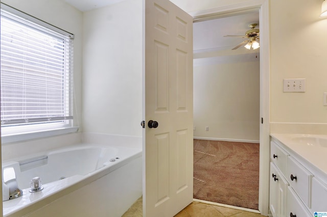 bathroom featuring vanity, a bathtub, tile patterned floors, and ceiling fan