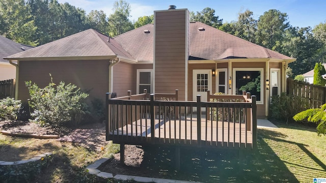 rear view of property featuring a yard and a deck