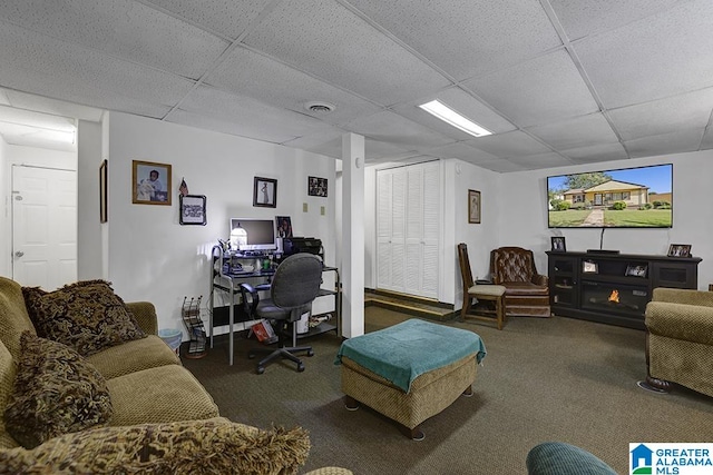 office area with dark carpet and a paneled ceiling