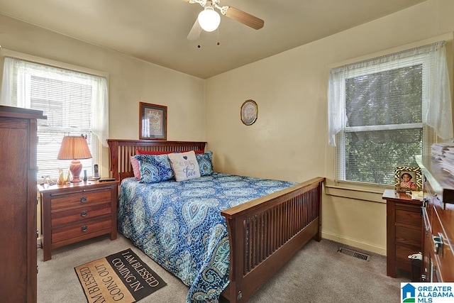 bedroom with ceiling fan and light colored carpet