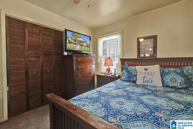 carpeted bedroom with ceiling fan and a closet