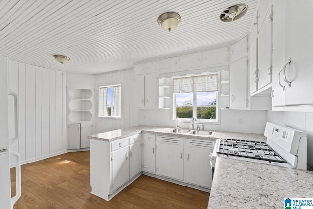 kitchen with sink, white stove, a wealth of natural light, white cabinets, and dark wood-type flooring