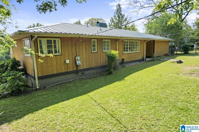 view of home's exterior featuring a lawn and cooling unit