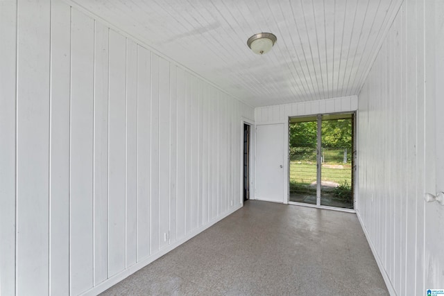 spare room with wooden walls