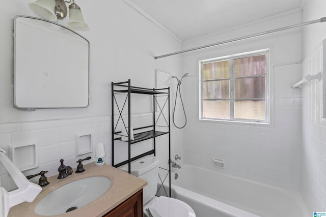 full bathroom with toilet, tiled shower / bath, crown molding, tile walls, and vanity