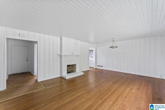 unfurnished living room with a fireplace and wood-type flooring