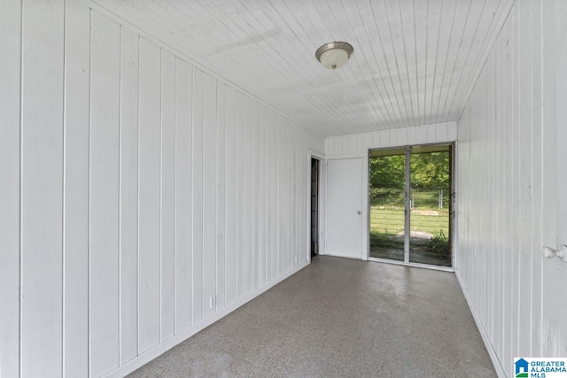 empty room featuring wood walls