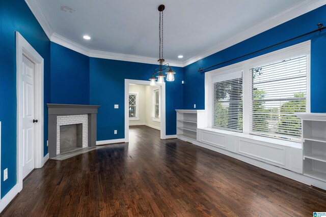 unfurnished living room featuring ornamental molding, a fireplace, dark wood-type flooring, and a chandelier