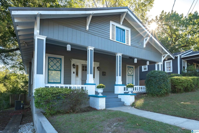 view of front facade with a porch and central AC