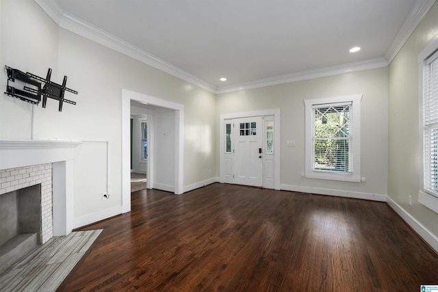 entryway with a fireplace, crown molding, and dark wood-type flooring