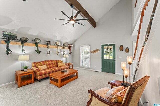 carpeted living room with high vaulted ceiling, beamed ceiling, and ceiling fan