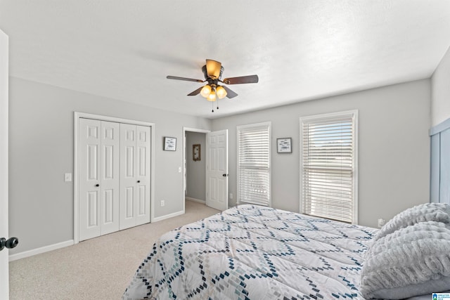 bedroom with light colored carpet, a textured ceiling, and ceiling fan