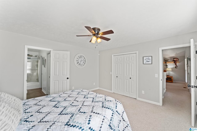 bedroom with light carpet, ensuite bath, and ceiling fan