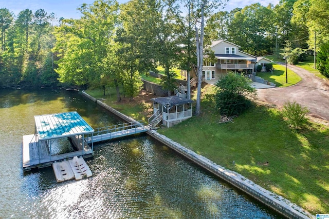 view of dock featuring a water view and a lawn