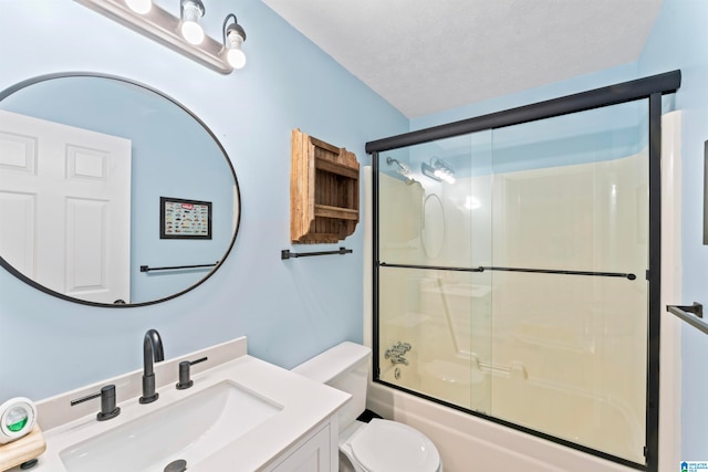 full bathroom featuring a textured ceiling, combined bath / shower with glass door, toilet, and vanity