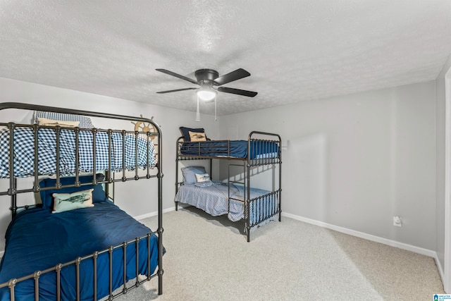 bedroom featuring ceiling fan, carpet, and a textured ceiling