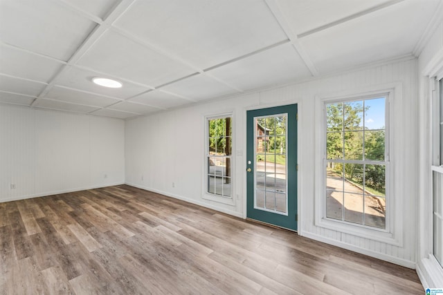 empty room featuring wood-type flooring and coffered ceiling