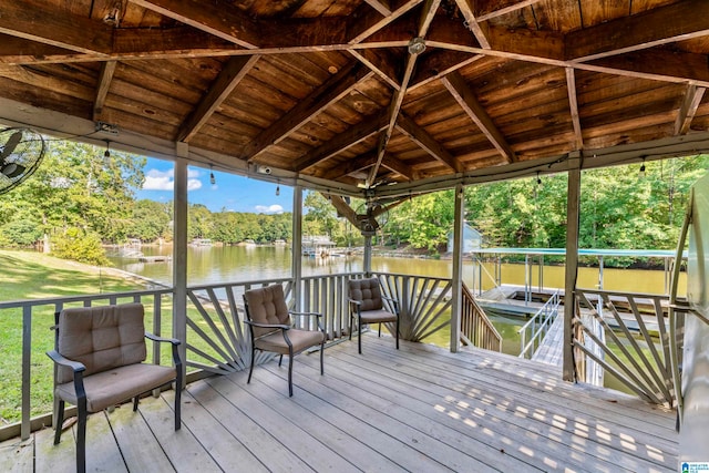 wooden terrace with a gazebo, a lawn, and a water view