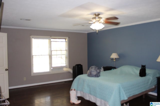 bedroom with dark hardwood / wood-style floors, ornamental molding, and ceiling fan