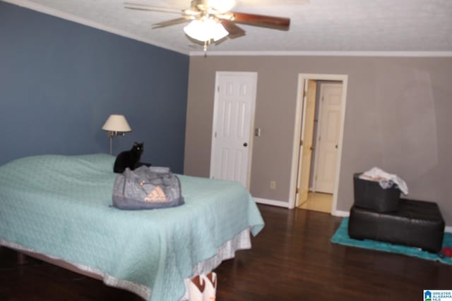 bedroom with ornamental molding, ceiling fan, and dark hardwood / wood-style flooring